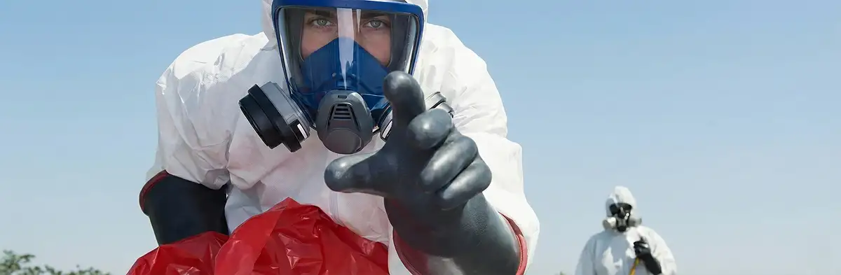 sewage clean up technician wearing protective gear handling biohazard materials in Jersey City, NJ