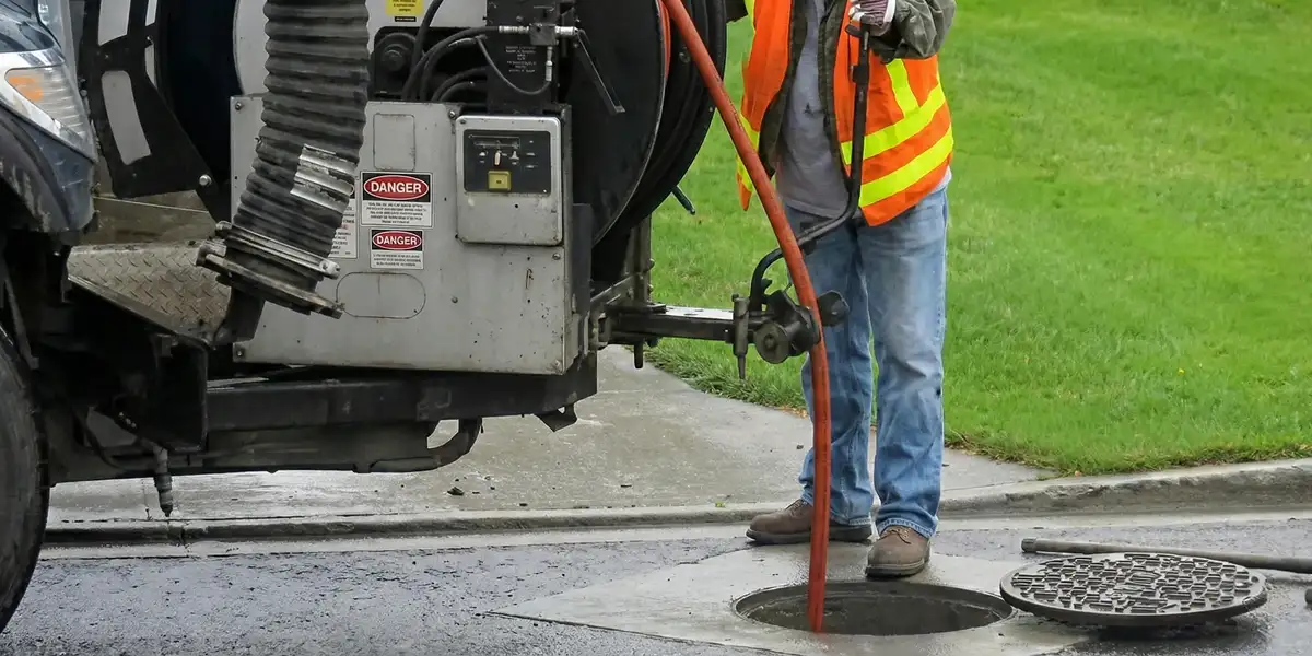sewage clean up professionals using industrial equipment to remove contaminated wastewater in Jersey City, NJ