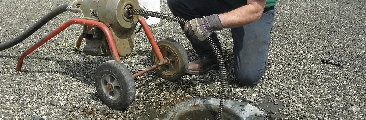 sewer rodding technician actively removing blockages from a sewer line in Jersey City, NJ