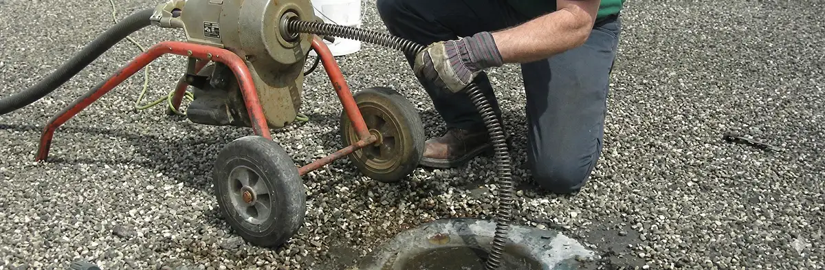 sewer rodding technician actively removing blockages from a sewer line in Jersey City, NJ