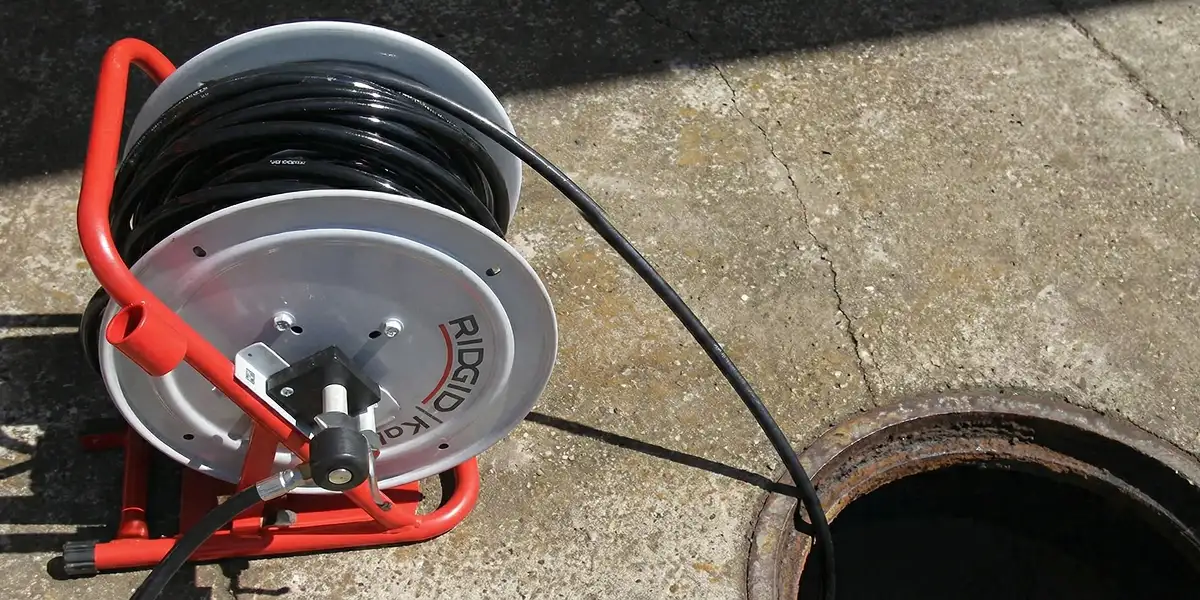 sewer rodding equipment prepared to clear clogged sewer lines in Jersey City, NJ